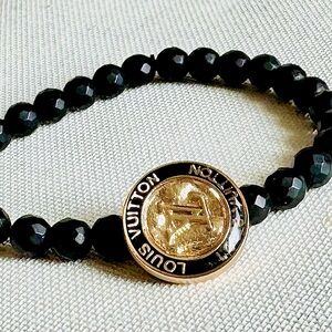 LOUIS VUITTON Black Beaded Bracelet with Gold LV Medallion